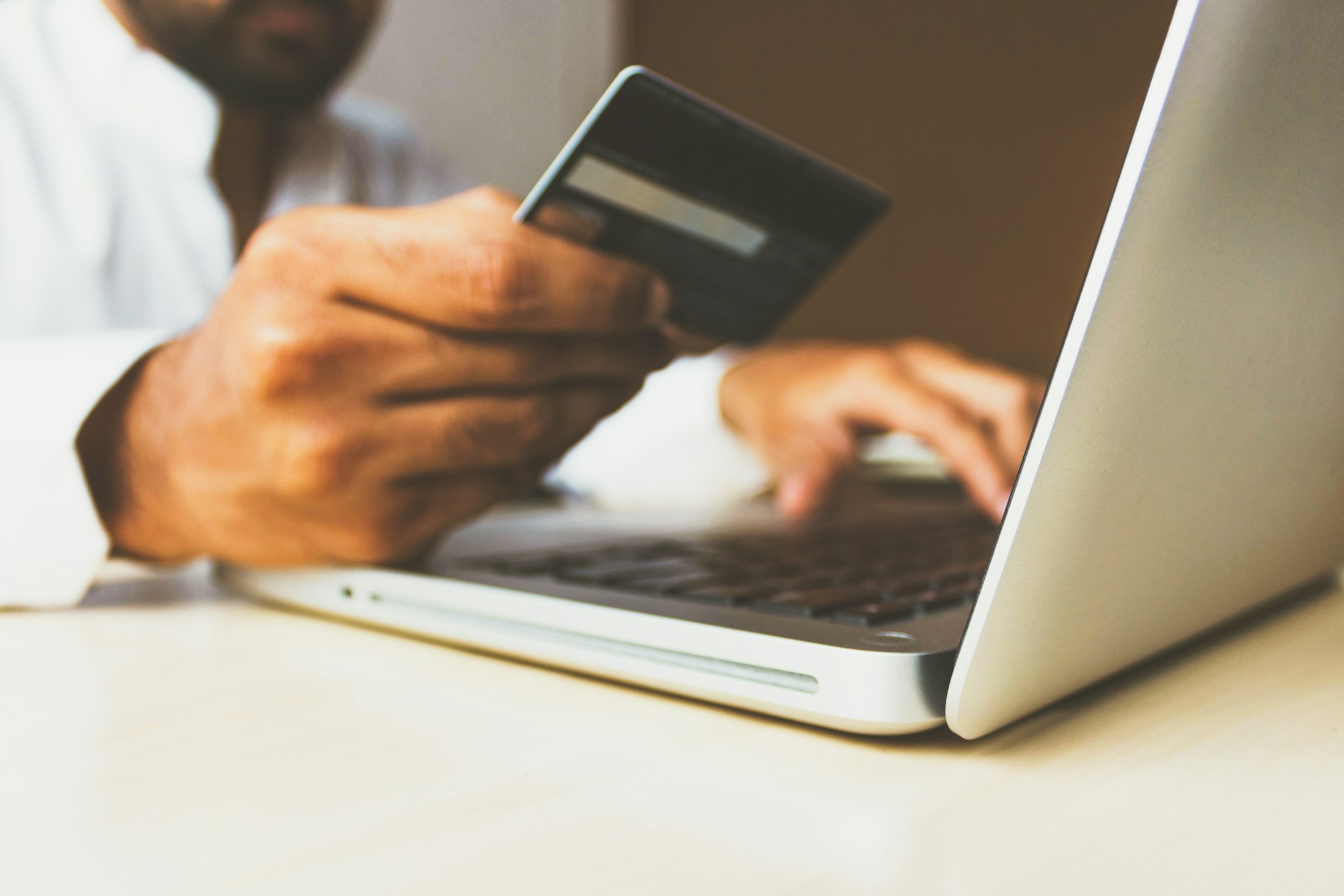 Shopping online with a credit card and laptop